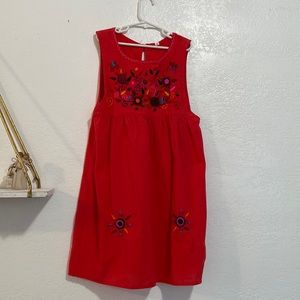 Red-orange cultural Guatemalan dress.